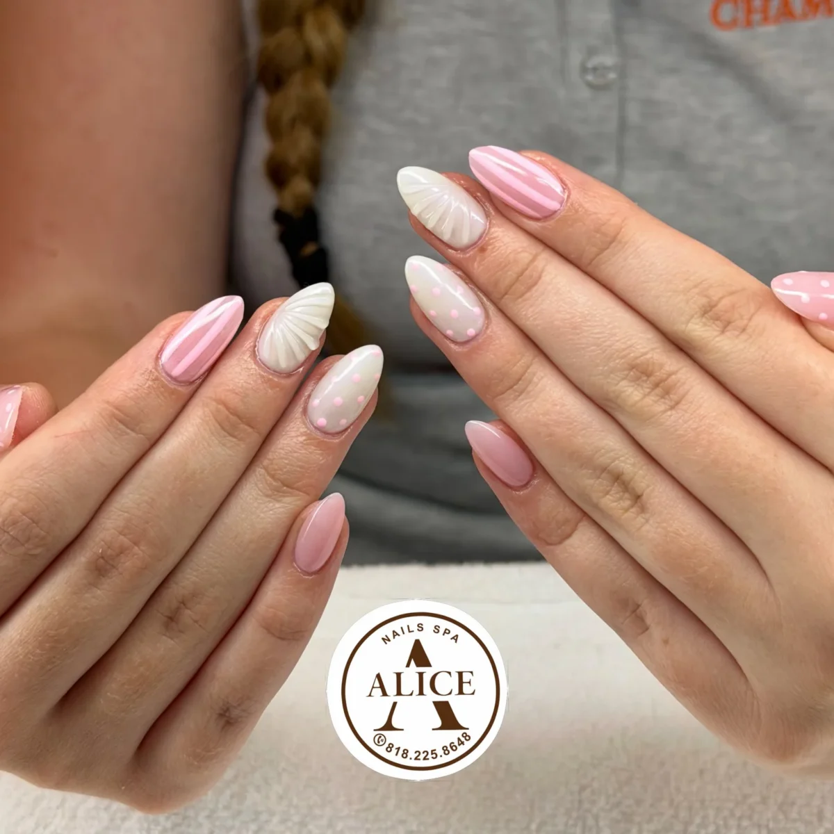 Almond nails in soft pink and white: pink and white stripes, white 3D seashells, milky white with pink dots, pink with white dots, and sheer pink